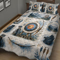 Rustic archery quilt bedding displayed on a bed with colorful target, bow, arrow, and woodland artwork