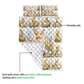 Rabbit quilt showing a colorful printed side with floral bunny scenes and a plain white quilted reverse