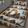 Close bedroom view of an excavator quilt blanket featuring yellow machinery, rocks, cones, and barriers