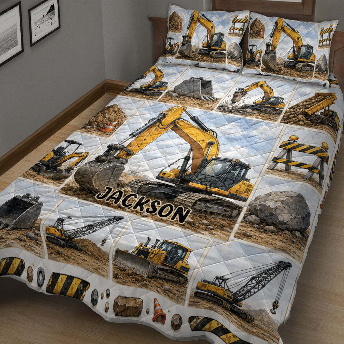 Close bedroom view of an excavator quilt blanket featuring yellow machinery, rocks, cones, and barriers