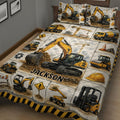 Construction vehicle quilt blanket shown across a bed with excavators and heavy equipment