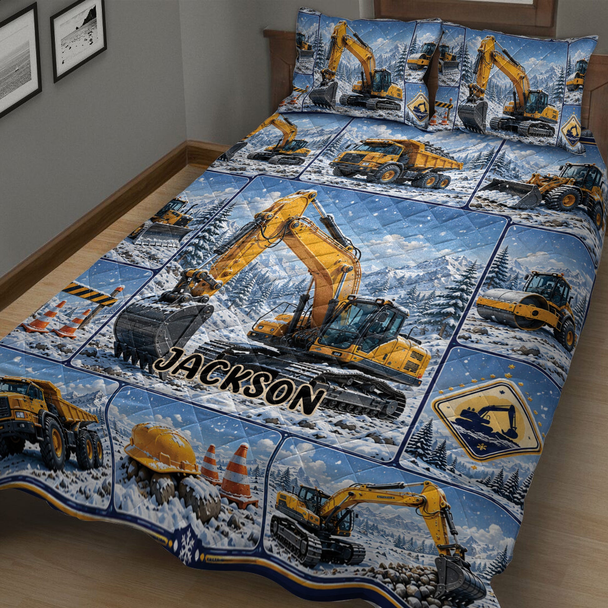 Close view of an excavator quilt blanket featuring heavy equipment, traffic cones, mountains, and winter scenery