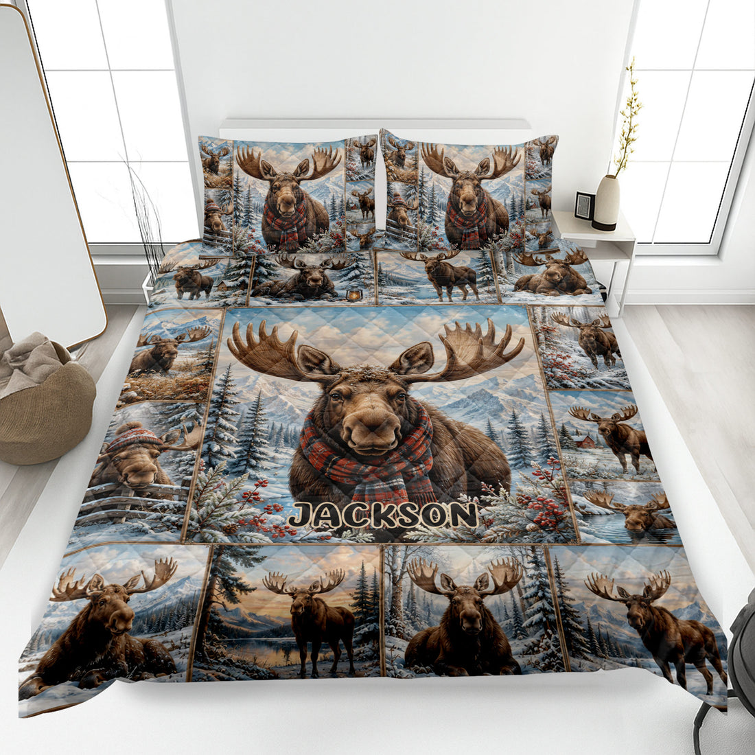 Moose quilt blanket displayed on a bed with snowy mountains, pine trees, and winter wildlife artwork