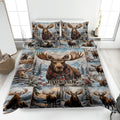 Moose quilt blanket displayed on a bed with snowy mountains, pine trees, and winter wildlife artwork