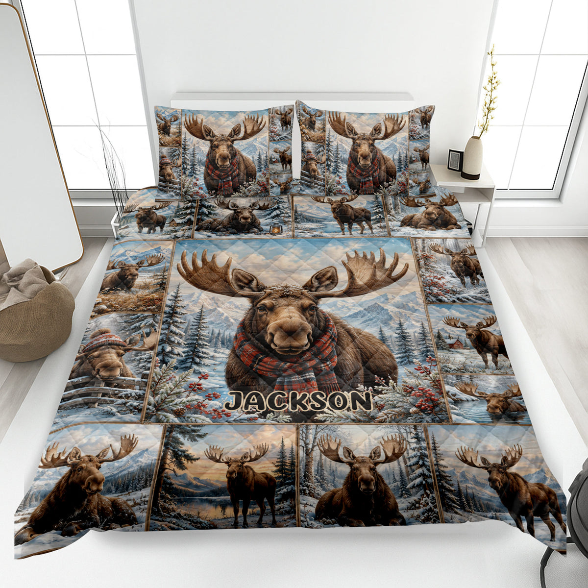 Moose quilt blanket displayed on a bed with snowy mountains, pine trees, and winter wildlife artwork