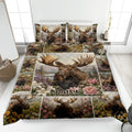 Moose quilt bedding set displayed on a bed with floral wildlife artwork and scenic mountain panels
