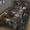 Close bedroom view of a wolf quilt featuring paired wolves, forest scenes, and a dark moonlit design