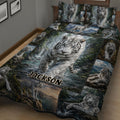 Close bedroom view of a tiger quilt with a large white tiger surrounded by forest and waterfall scenes