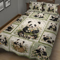 Close bedroom view of a panda quilt blanket featuring playful pandas, daisies, and soft green borders