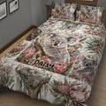 Close bedroom view of a koala quilt blanket with eucalyptus leaves and pink Australian flowers