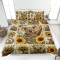 Koala quilt blanket displayed on a bed with sunflowers, eucalyptus leaves, and Australian wildlife artwork