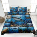 Shark quilt bedding set displayed on a bed with blue underwater artwork, coral, shells, and ocean life
