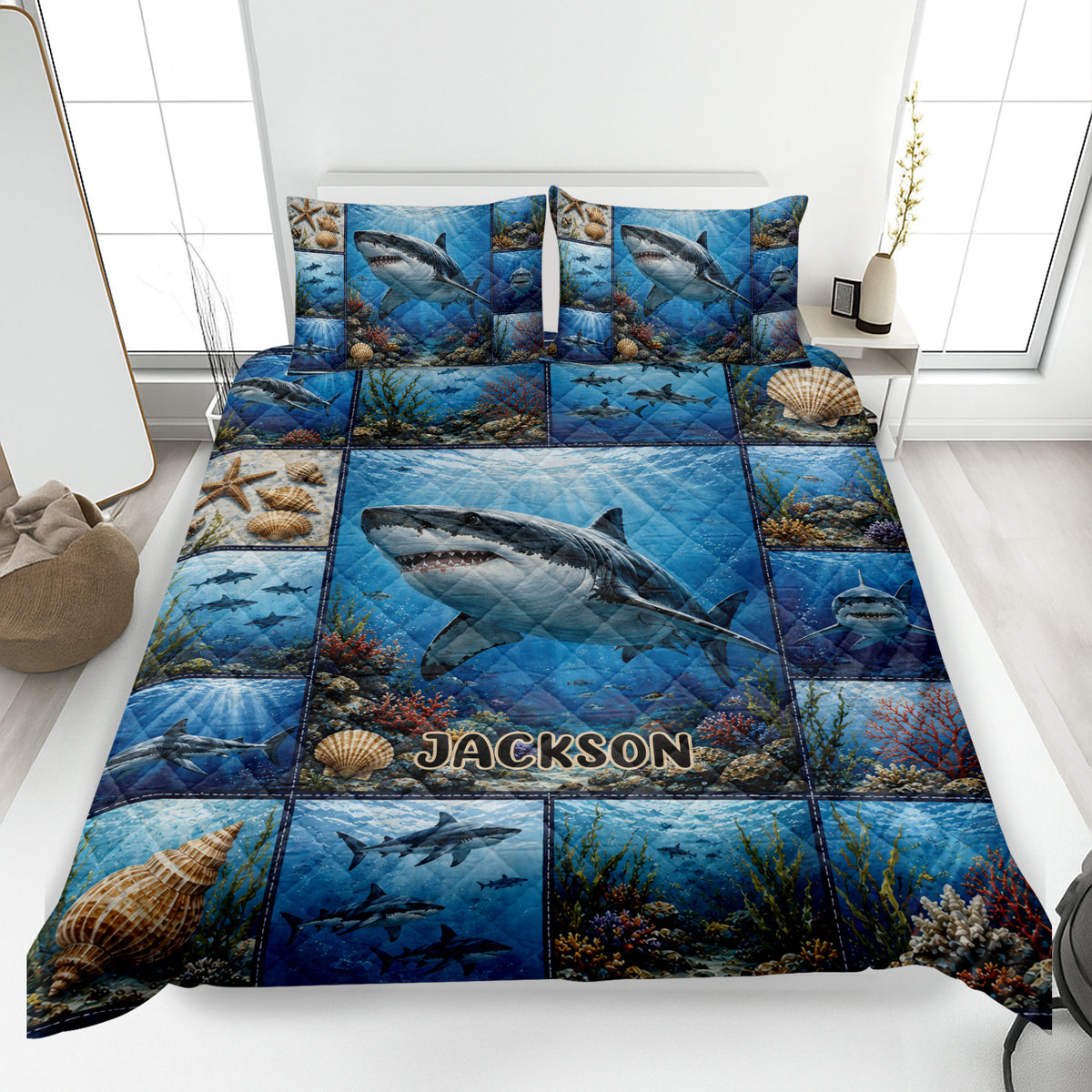 Shark quilt bedding set displayed on a bed with blue underwater artwork, coral, shells, and ocean life