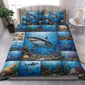 Shark quilt blanket styled in a bright bedroom with ocean scenes, coral, shells, and multiple sharks