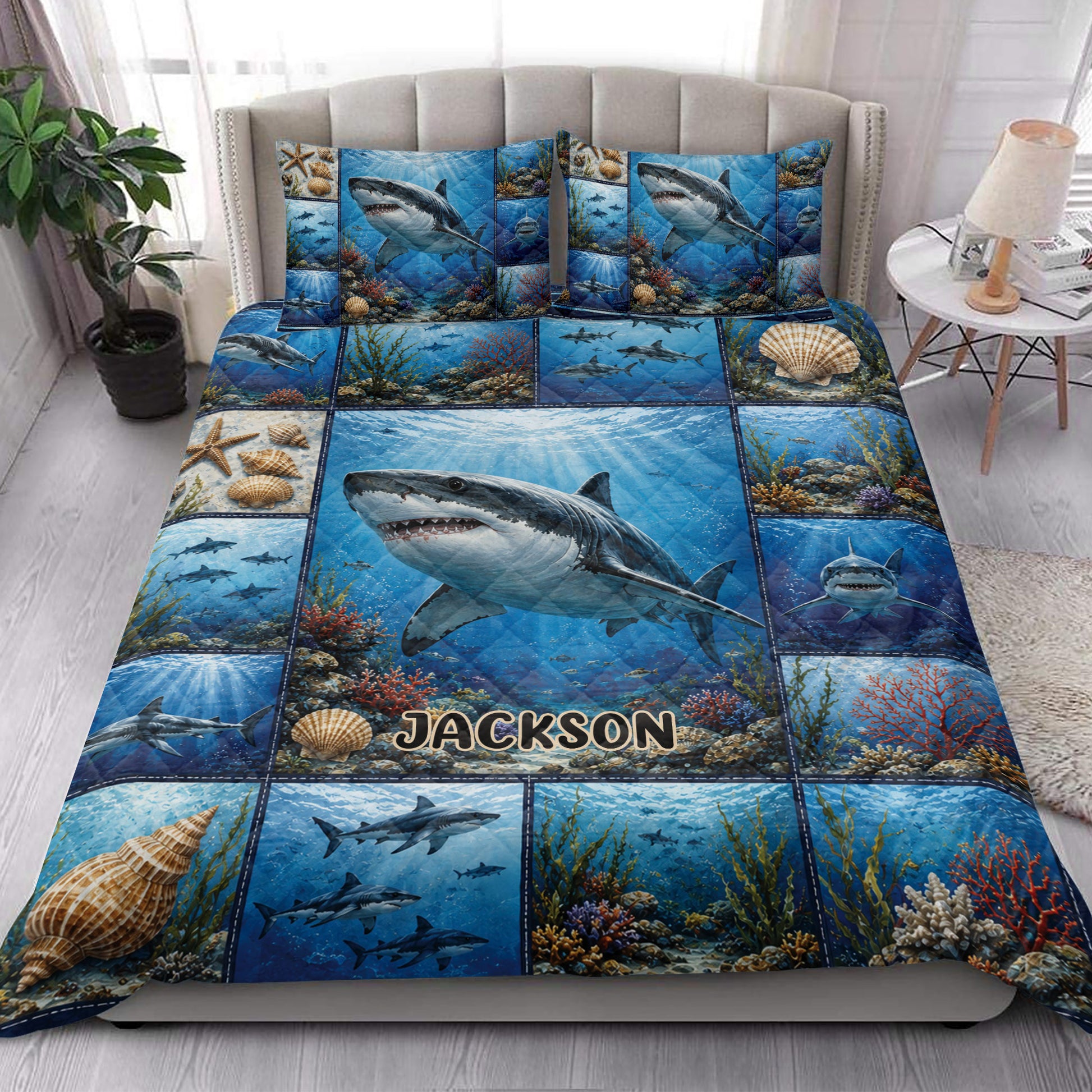 Shark quilt blanket styled in a bright bedroom with ocean scenes, coral, shells, and multiple sharks