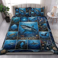 Shark quilt blanket styled in a bright bedroom with coral reefs, sea turtles, fish, and ocean scenes