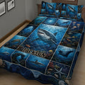 Close bedroom view of a shark quilt blanket with underwater panels, coral reefs, and marine life