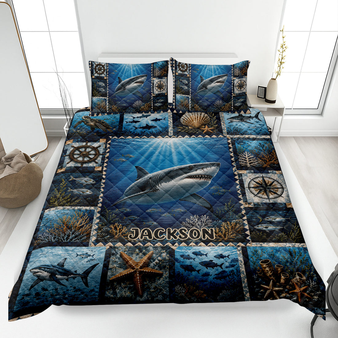 Shark quilt blanket displayed on a bed with underwater scenes, coral, fish, and nautical compass artwork