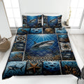Shark quilt blanket displayed on a bed with underwater scenes, coral, fish, and nautical compass artwork