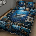 Close view of shark quilt bedding with deep blue ocean artwork, coral, fish, and nautical details