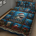 Close bedroom view of a Christmas shark quilt blanket with ocean scenes, sea life, and holiday details