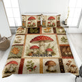 Mushroom quilt blanket displayed on a bed with forest fungi, ferns, leaves, and rustic woodland artwork