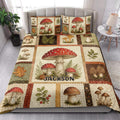Mushroom quilt blanket styled in a bright bedroom with red-capped fungi, leaves, and rustic forest artwork