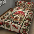 Close bedroom view of a mushroom quilt blanket featuring a large red toadstool, holiday greenery, and woodland scenes