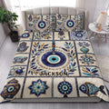 Evil Eye quilt bedding set styled in a bright bedroom with blue eyes, botanical details, and bohemian decor