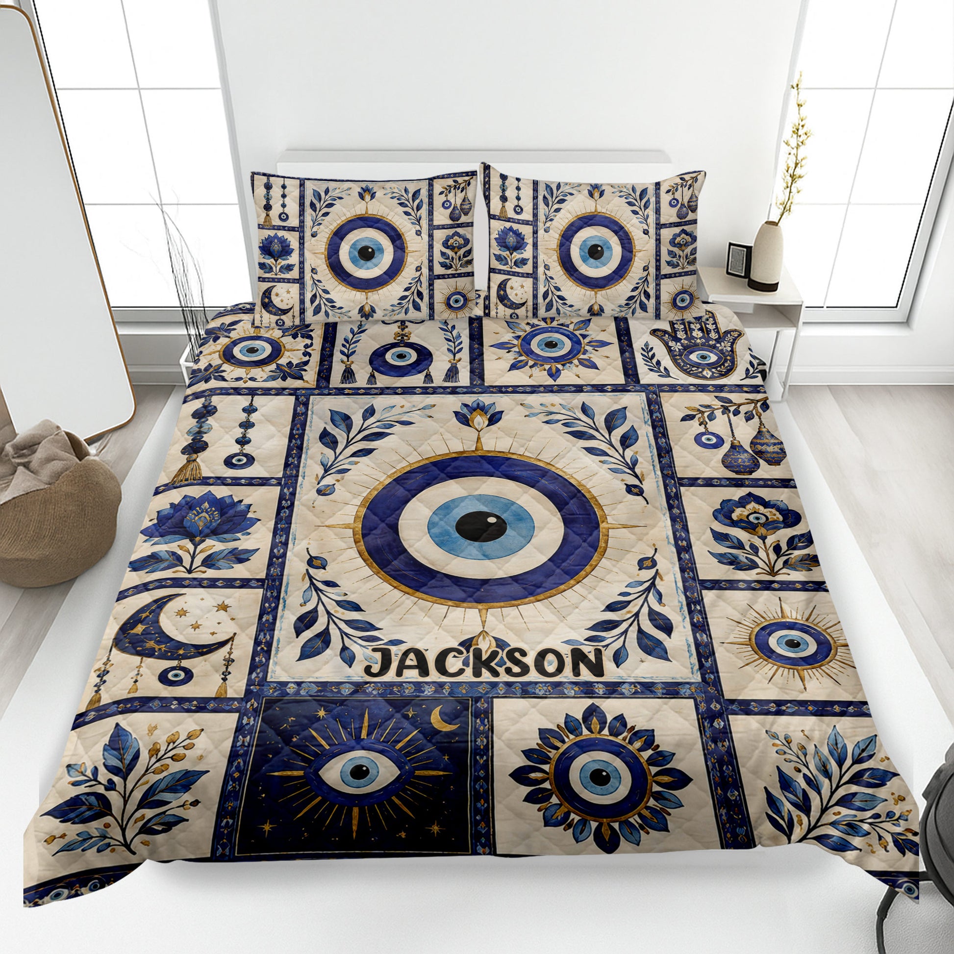 Evil Eye quilt blanket bedding set displayed on a bed with blue, cream, and gold protective eye artwork