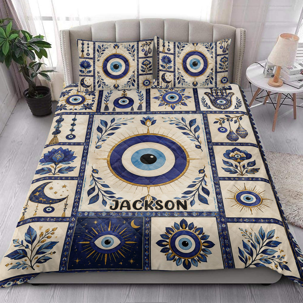 Evil Eye quilt blanket styled in a bright bedroom with blue and gold decorative artwork