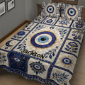 Close bedroom view of an Evil Eye quilt featuring Hamsa, moon, floral, and circular eye motifs