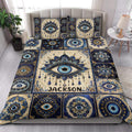 Evil Eye quilt blanket styled on a bedroom bed with bold blue, cream, and gold ornamental artwork