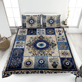 Evil Eye quilt blanket displayed on a bed with blue and cream ornamental eye motifs