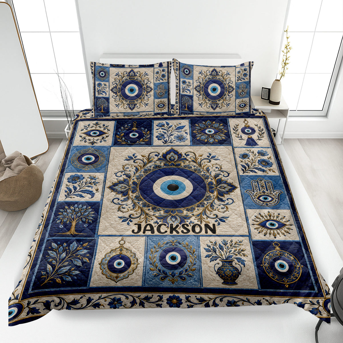 Evil Eye quilt blanket displayed on a bed with blue and cream ornamental eye motifs