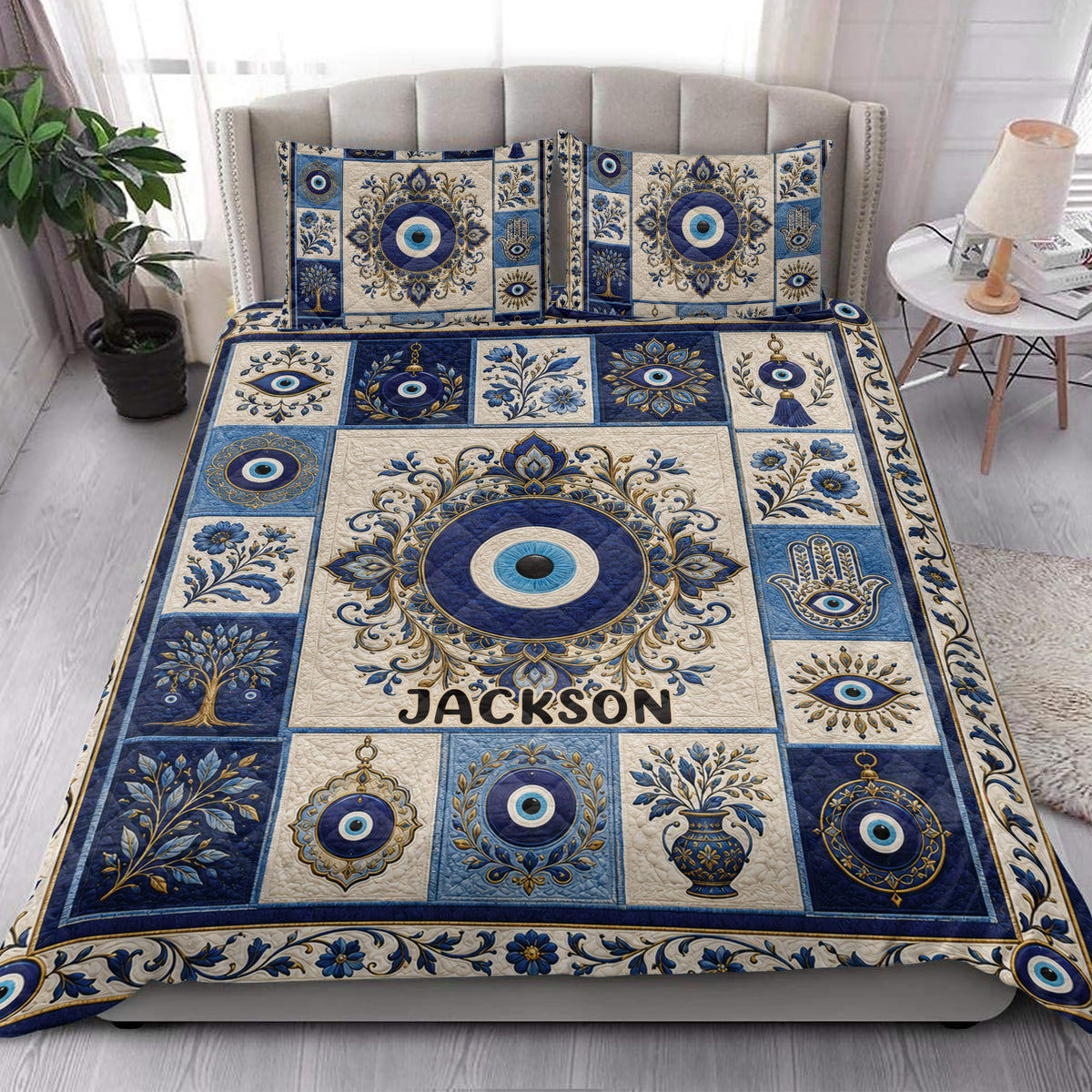 Blue and cream Evil Eye quilt blanket styled across a modern bedroom with matching design details