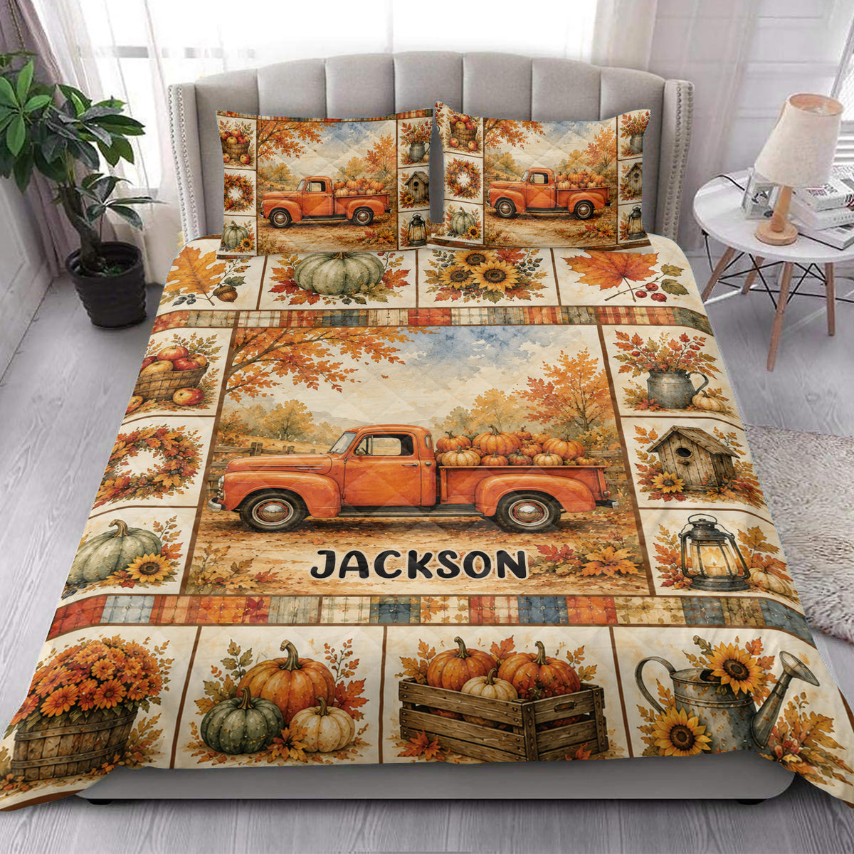 Autumn quilt blanket styled on a bedroom bed with orange pickup truck, pumpkins, sunflowers, and maple leaves