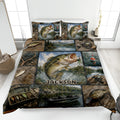 Fishing quilt blanket displayed on a bed with bass, lures, fishing gear, lake scenes, and a custom design detail