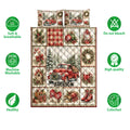 Full view of a Christmas quilt blanket with vintage truck scenes, ornaments, candy canes, and holiday patchwork