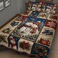 Close view of a Christmas quilt blanket featuring snowmen, mittens, skates, lanterns, wreaths, and gifts