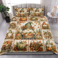 Autumn gnome quilt blanket styled in a bright bedroom with pumpkin, mushroom, cottage, and leaf artwork