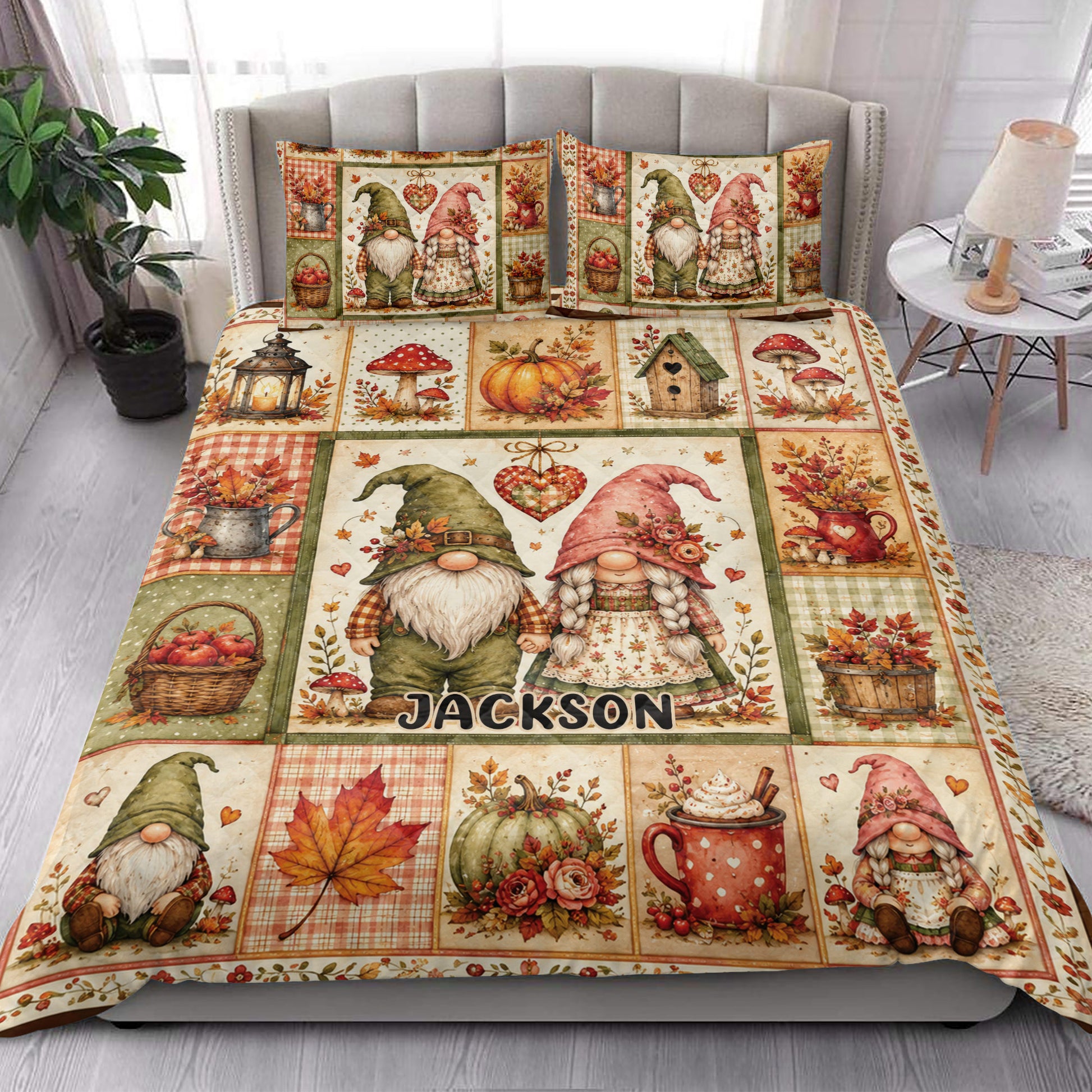 Gnome quilt blanket styled on a bedroom bed with colorful fall leaves, pumpkins, mushrooms, and harvest motifs
