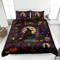 Witchcraft quilt blanket displayed on a bed with witch, moon, bat, pumpkin, candle, and skull artwork