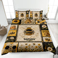 Bee quilt blanket displayed on a bed with honeybees, sunflowers, daisies, honeycomb, and beehive artwork