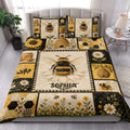 Bee quilt blanket styled on a bed with honeybees, sunflowers, daisies, honeycomb, and beehive panels