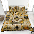Bee quilt blanket spread on a bed with flowers, honeycomb details, beehives, and a custom center design