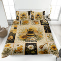 Bee quilt blanket displayed on a bed with honeycomb, beehive, honey jar, and floral artwork