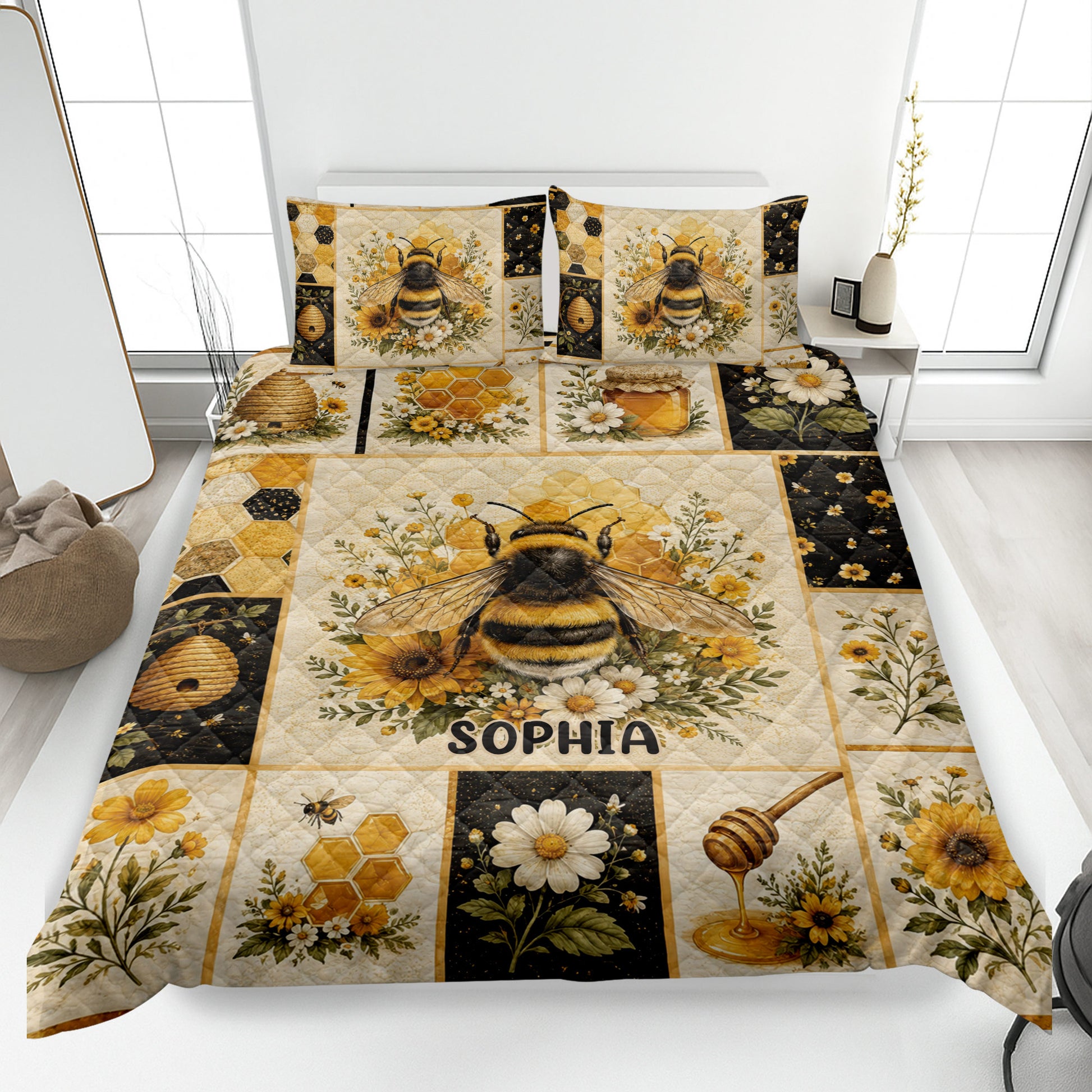 Bee quilt blanket displayed on a bed with honeycomb, beehive, honey jar, and floral artwork