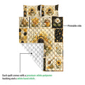 Bee quilt close-up showing the printed floral front and white diamond-stitched backing