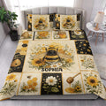 Bee quilt blanket styled in a bright bedroom with honeybees, flowers, honeycomb, and honey artwork